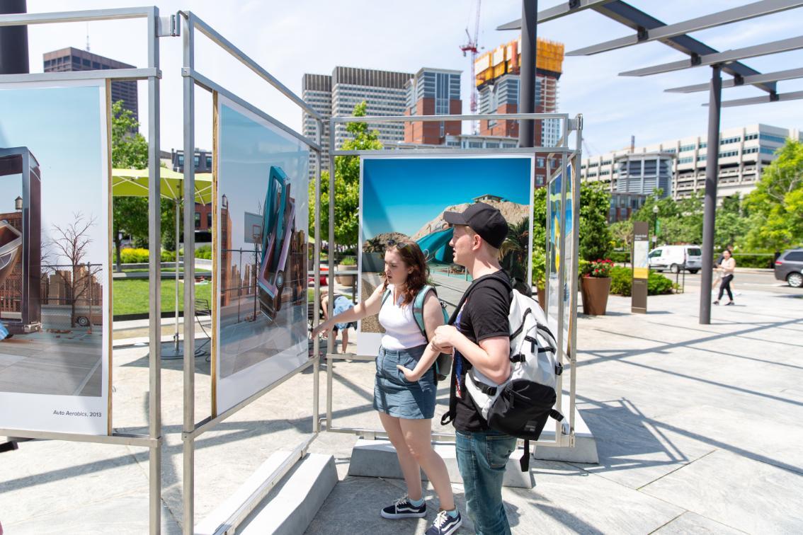 Students looking at art on the street