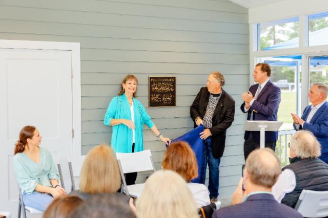 L to R: Christine Ober Bridge and Ric Arenstein unveil a plaque during the dedication of the new Policy Pavilion at the Baliles Center as Longwood President W. Taylor Reveley and Longwood Real Estate Foundation President John W. Daniel II look on. Bridge, Arenstein and Daniel all worked in the administration of the late Gov. Gerald L. Baliles.